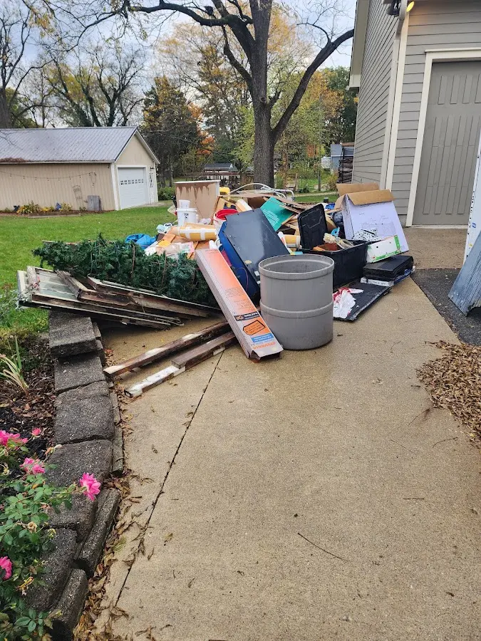 Dumpster being loaded with debris for 10 Yard Dumpster Rental in Valdez